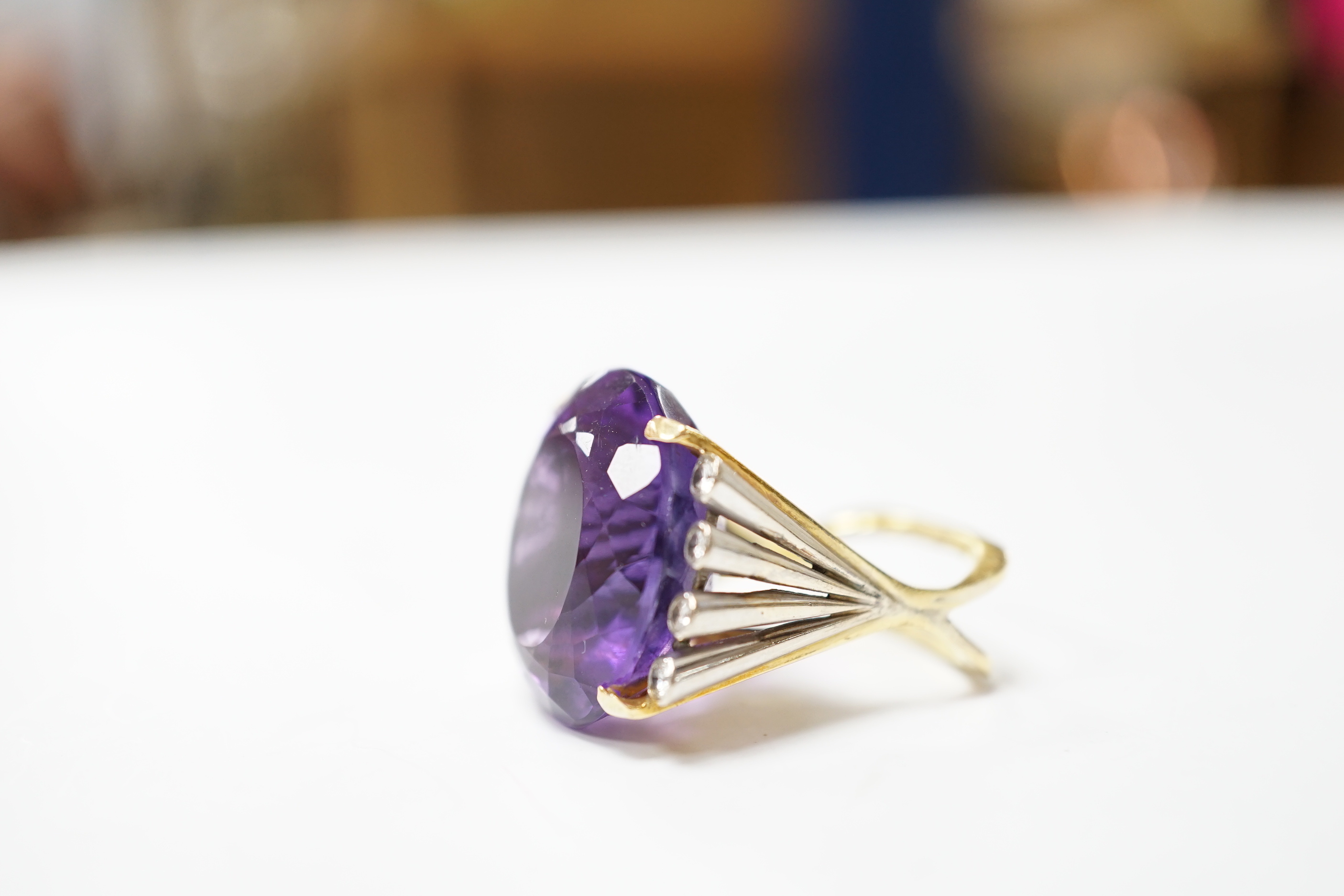 A large yellow and white metal and single stone oval cut amethyst set dress ring, flanked by eight small round cut diamonds, size K, gross weight 15.3 grams.